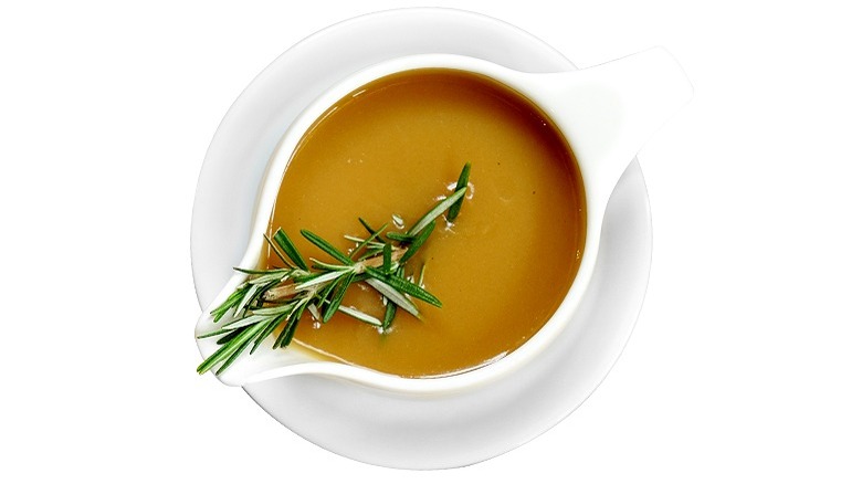 Gravy in boat with rosemary 