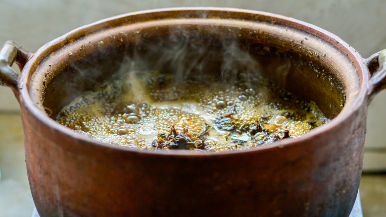 Soup bubbling in clay pot