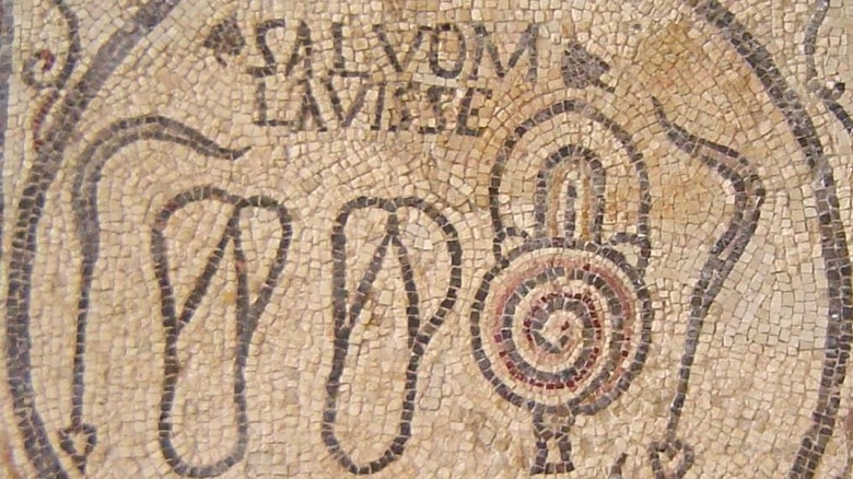 Mosaic sign from a Roman bathhouse showing oil bottles and strygils.