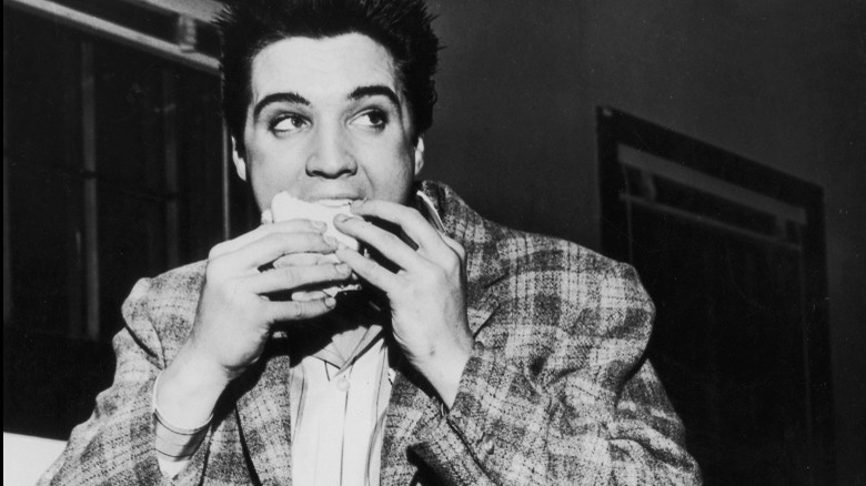 Young Elvis eating sandwich