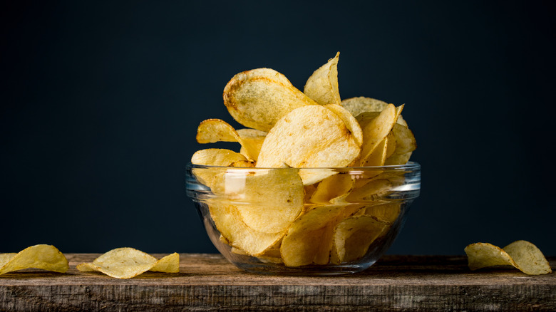 bowl overflowing with potato chips