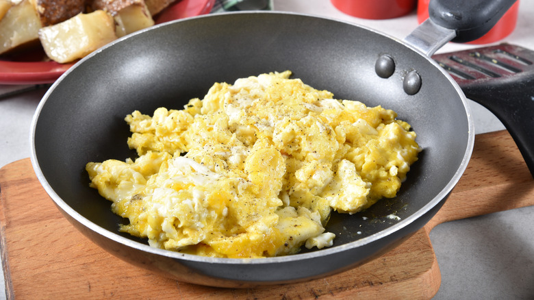 cooked scrambled eggs in frying pan