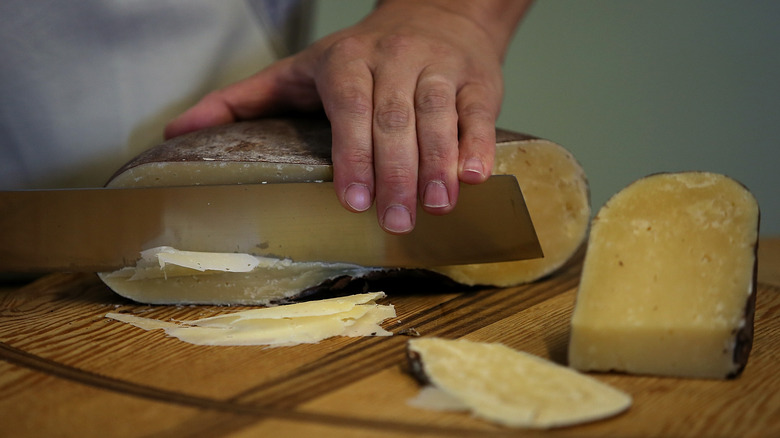 cheesemaker cutting Dry Jack cheese