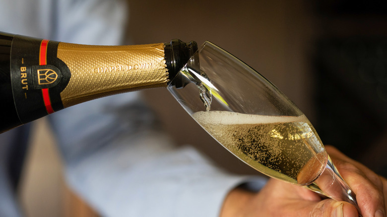 Pouring Champagne into a fluted glass