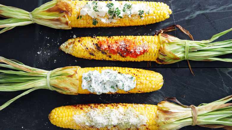 Corn on the cob with different toppings