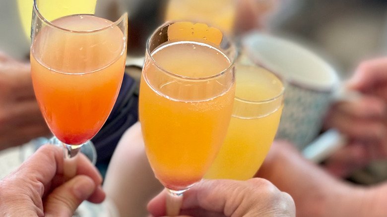 mimosas raised for a toast 