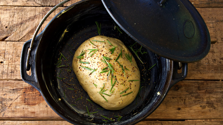 Overhead view of dough in a cast iron Dutch oven