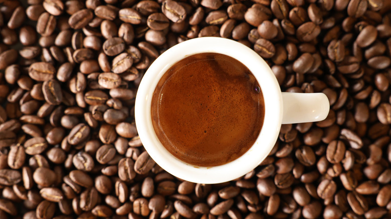 Espresso shot atop coffee beans