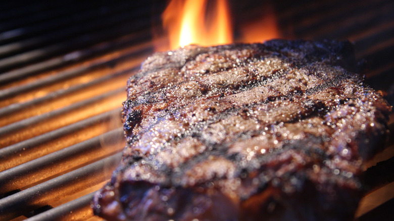 steak searing on the grill