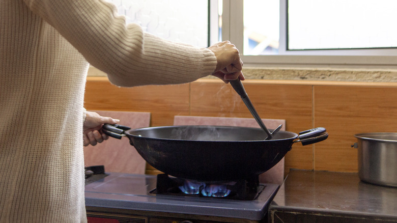 woman using wok