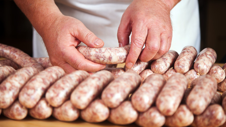 Butcher making sausages