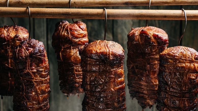 smoked meat hanging by hooks