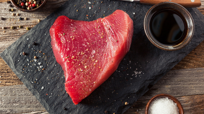 raw tuna steak on black board