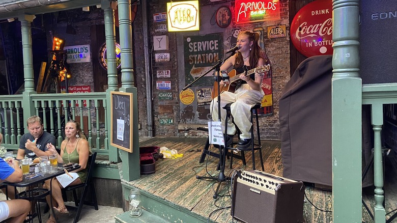 Musician singing on stage at Arnold's Bar and Grill