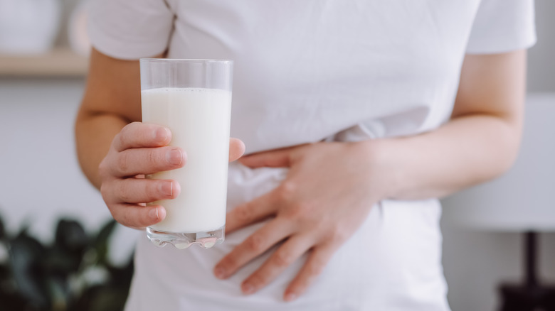 Person holding glass of milk