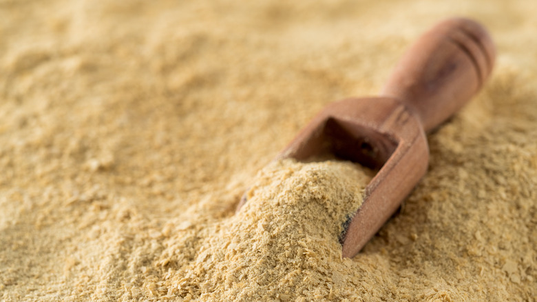 Nutritional yeast with wooden scoop