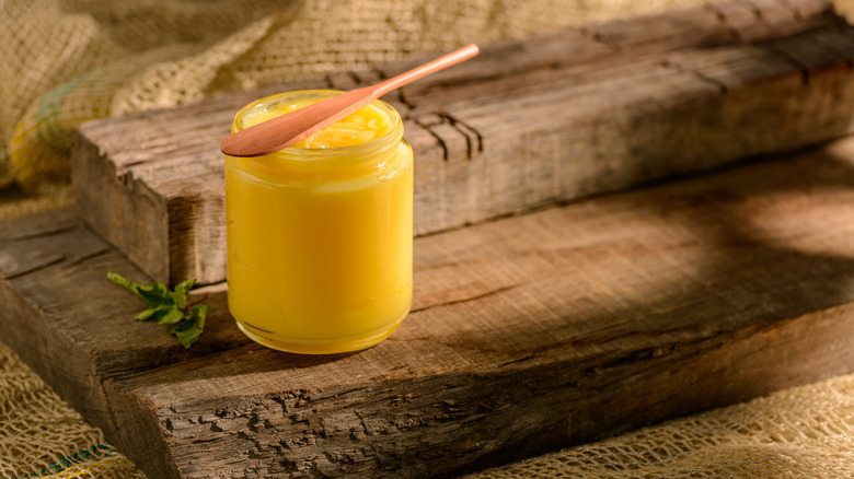 Jar of ghee on wood