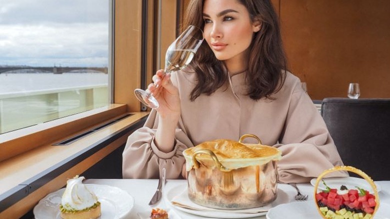 Woman with wine, food on cruise