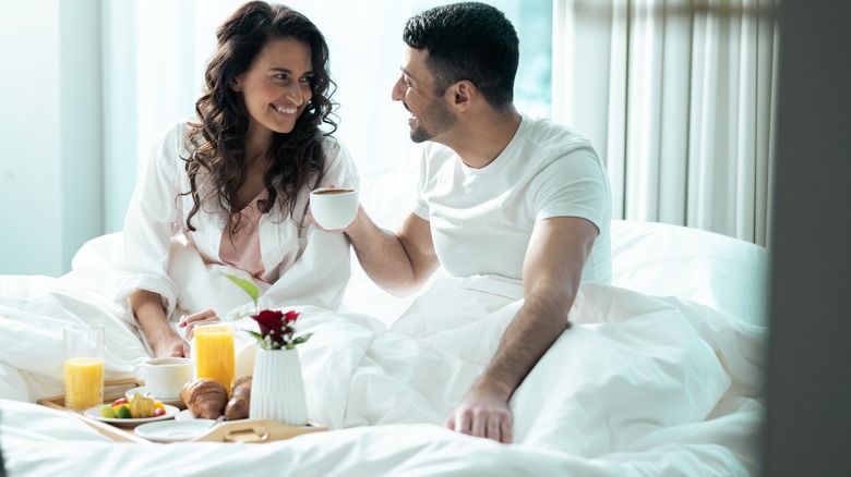 Couple enjoying breakfast in bed