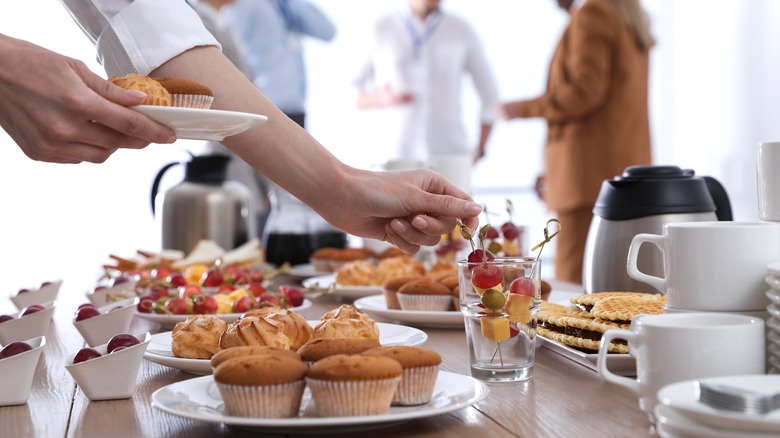 Person grabbing breakfast from buffet