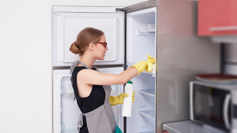 woman cleaning fridge and freezer