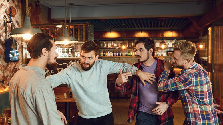 men fighting inside restaurant