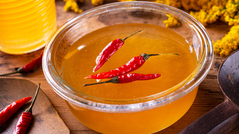 Bowl of hot honey with dried chilies floating on top