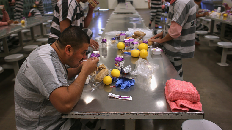 Inmates eating breakfast in prison