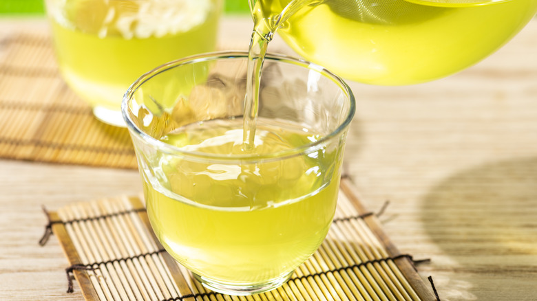 green tea pouring into cup