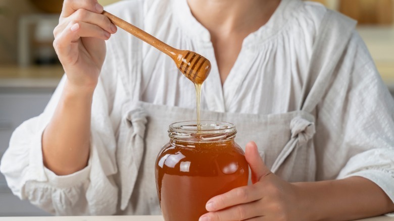 honey in bowl with hands