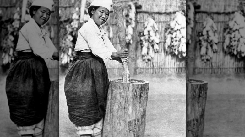 person making miso in stump