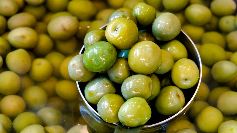 green olives being scooped