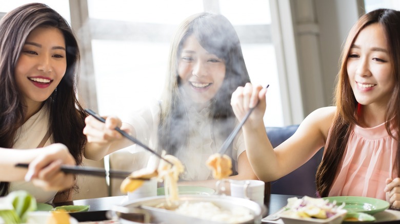 Eating hotpot with chopsticks