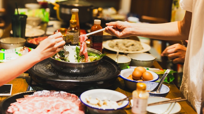 People sharing hotpot dinner