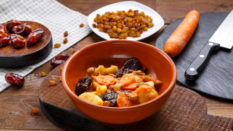 Bowl of tzimmes and ingredients