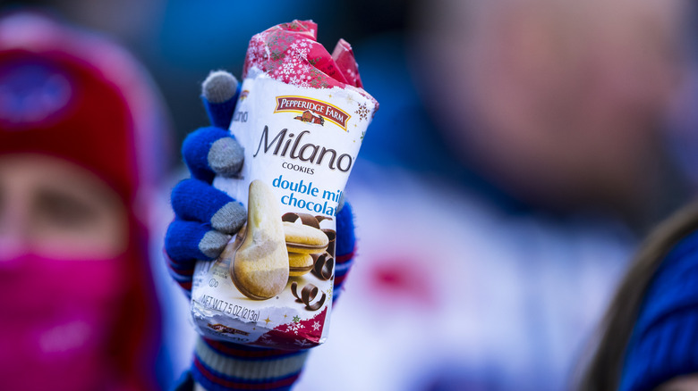 Hand holding bag of Milano cookies