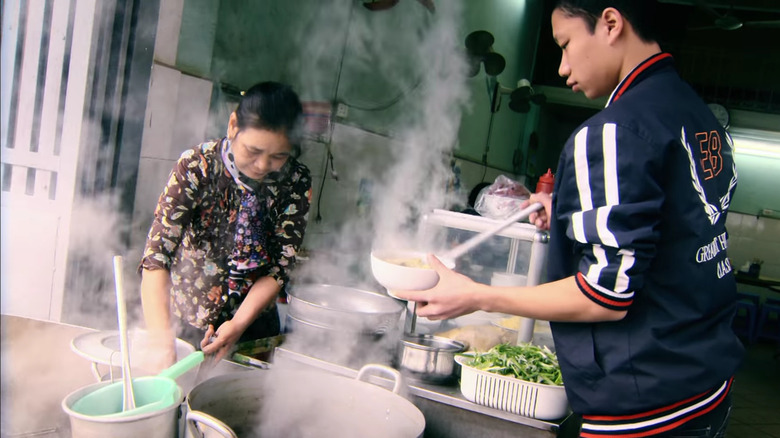 Two people serving pho