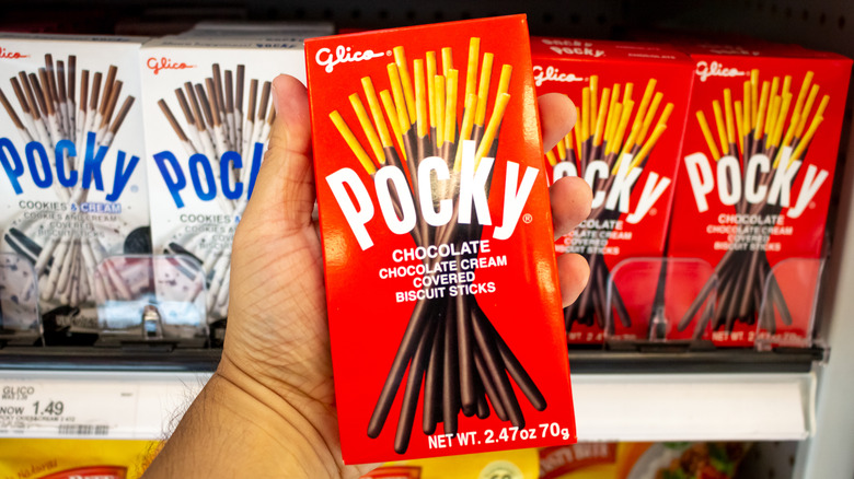 Hand holding red pocky box