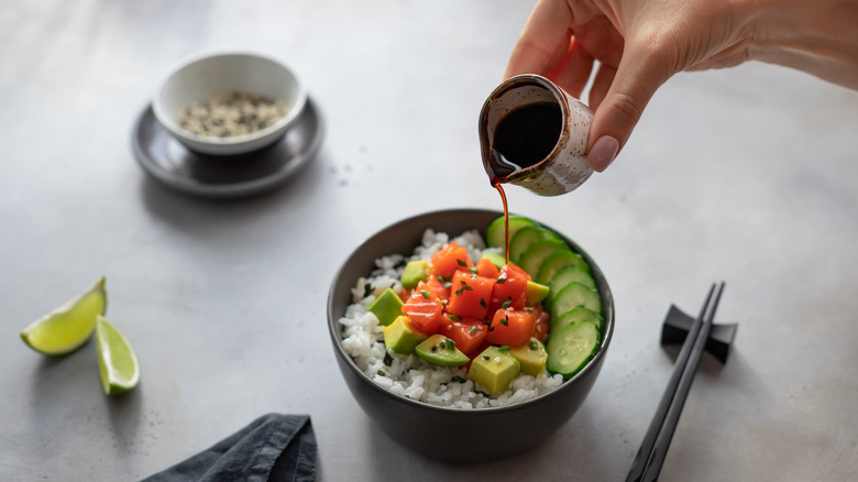 Sauce pouring on Poke bowl