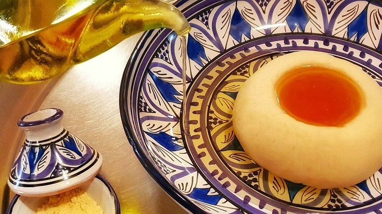 Bowl of aseeda with honey and olive oil