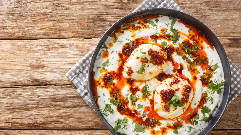 Bowl of Turkish poached eggs in yogurt