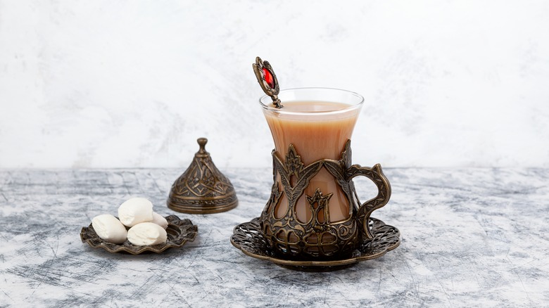 Ornate cup of milky ginger tea