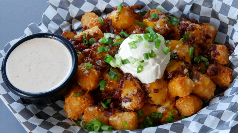 Cup of ranch dressing with tots