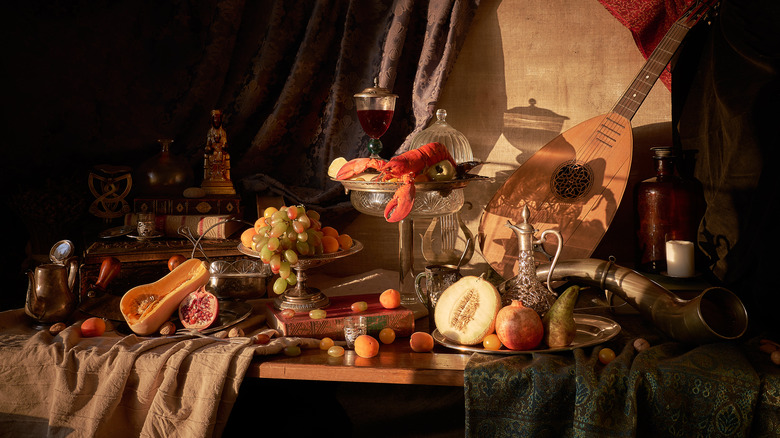 Still life photograph of fruits like melon, apricots, pomegranate, and squash, on a table with wine and a lute