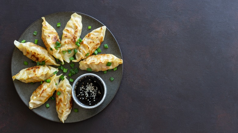 Plate of jiaozi dumplings with soy sauce