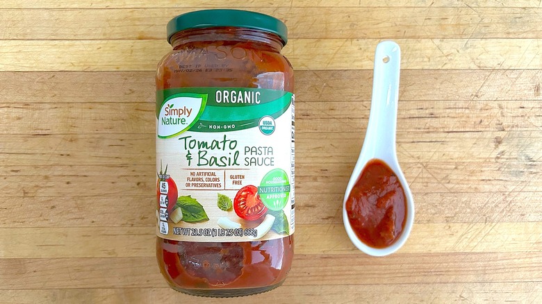 Jar and spoonful of Simply Nature Organic Tomato & Basil Pasta Sauce