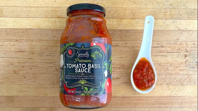 Jar and spoonful of Specially Selected Premium Tomato Basil Sauce