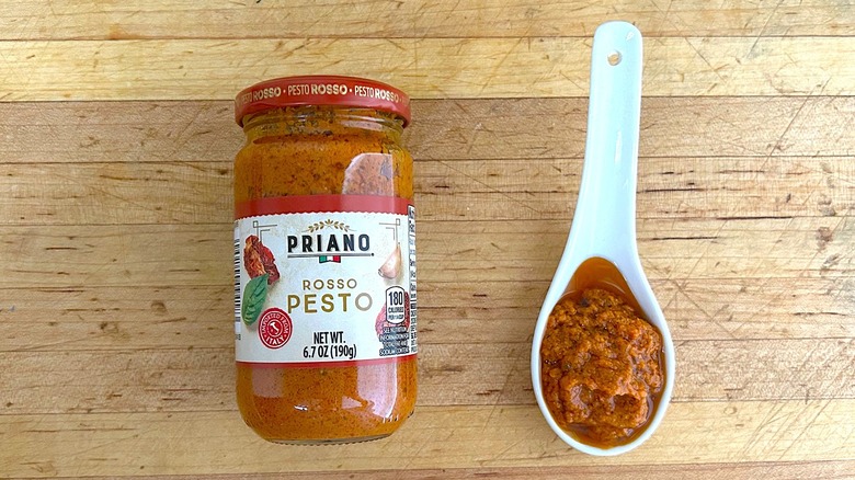 Jar and spoonful of Priano Rosso Pesto