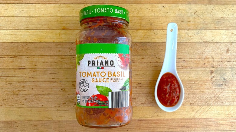 Jar and spoonful of Priano Tomato Basil Sauce