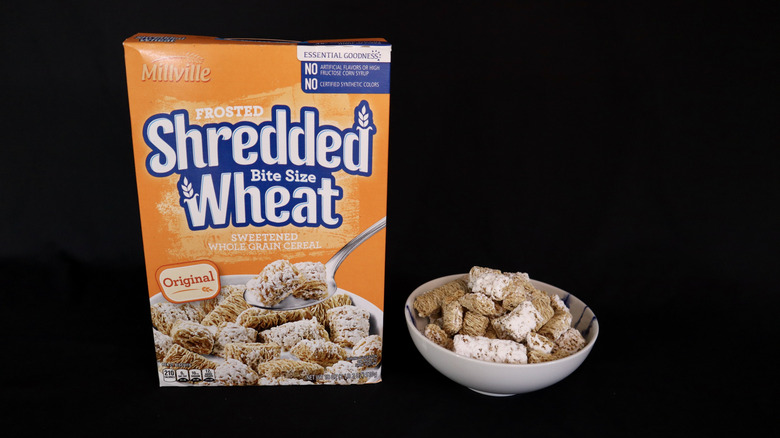 Frosted Shredded Wheat box next to a bowl of cereal.